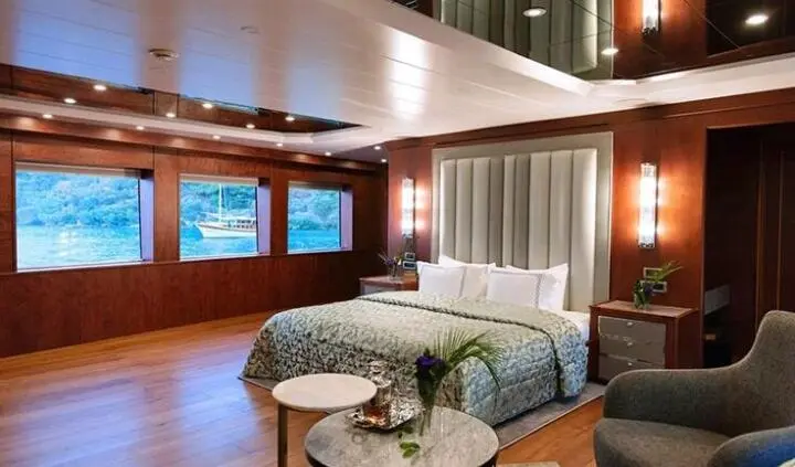 Master cabin with king bed, ensuite, and panoramic windows on Ocean Breeze