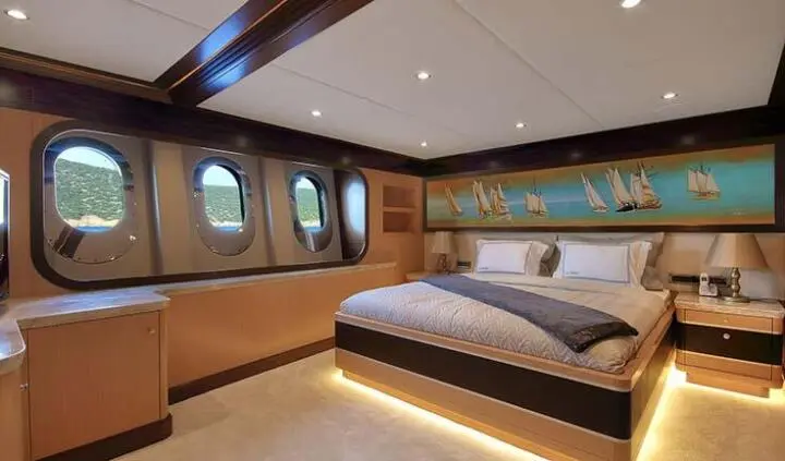 Meira yacht master cabin with king bed, wood accents, ensuite feel, warm lighting