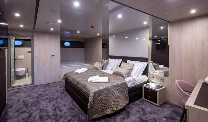 Dalmatino master cabin with king bed, ensuite, plush bedding, soft lighting