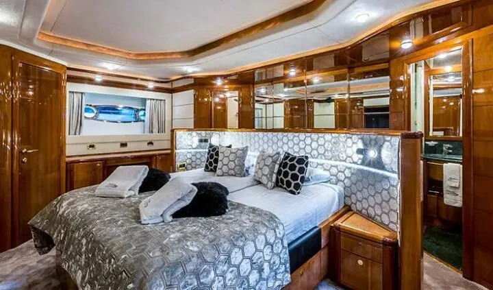Miss Katariina master cabin with king bed, wooden ceiling, and built-in cabinetry