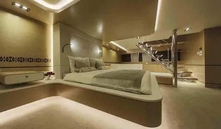 Omnia master cabin with king bed, ensuite, soft lighting, beige tones