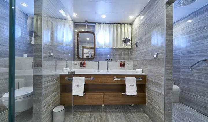 Guest cabin ensuite bathroom on Corsario yacht, wooden vanity and mirror