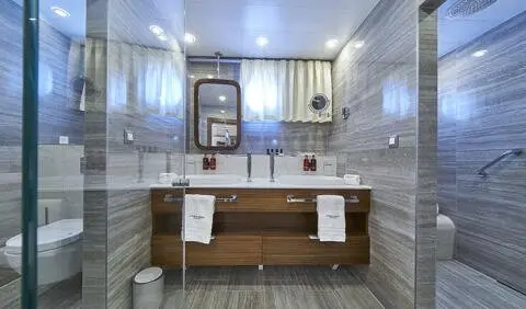Guest cabin ensuite bathroom on Corsario yacht, wooden vanity and mirror