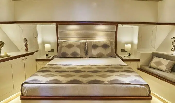 Grand Sailor yacht master cabin with king bed and en-suite bathroom visible