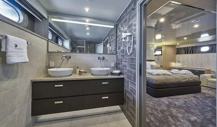 Dalmatino cabin interior with dark wood cabinetry and ensuite bathroom