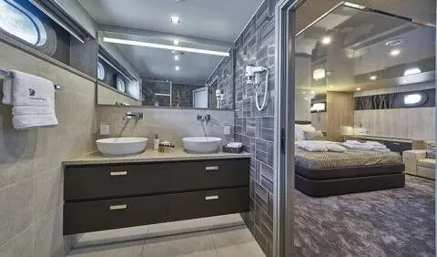 Dalmatino cabin interior with dark wood cabinetry and ensuite bathroom