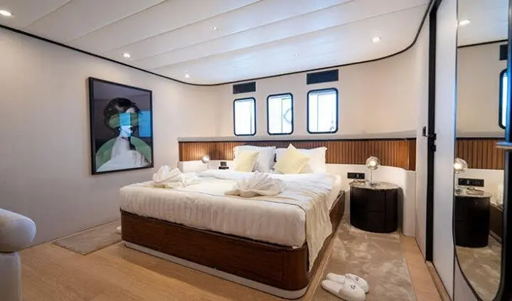 Master cabin with king bed, ensuite, wood accents, windows, wardrobe