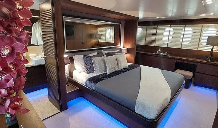 Miraval yacht master cabin with king bed and en suite, dim ambient lighting