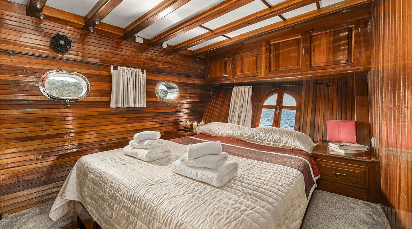 Luxurious wooden cabin with two neatly made beds and warm bedding