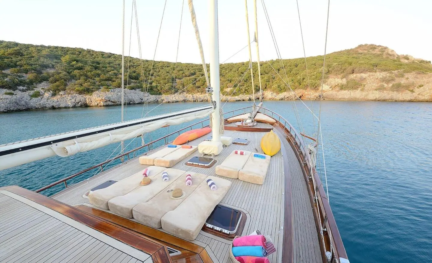 On the Samarkand yacht, sun loungers and cushions on the deck with water nearby