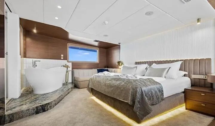 Bella yacht master cabin with king bed, ensuite, neutral tones, ambient lighting