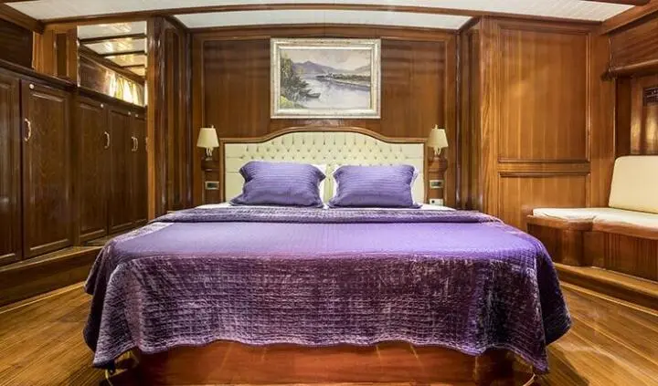 Grace 1 yacht master cabin with king bed and purple quilted bedspread