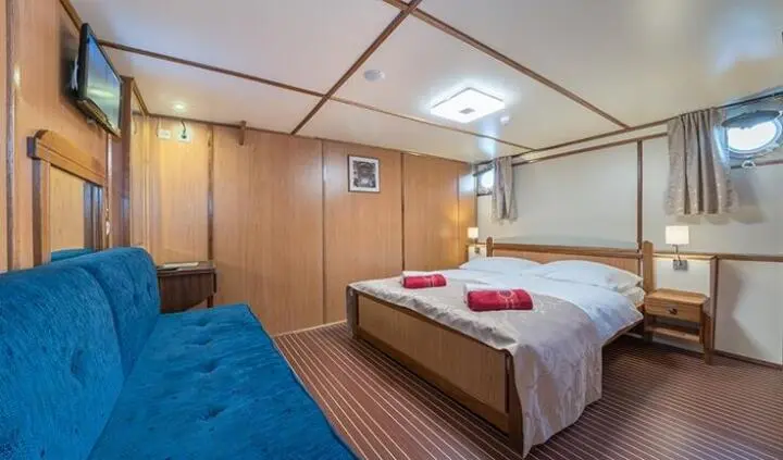 Barbara yacht cabin with two single beds and wooden paneling interior
