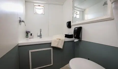 Cabin aboard Aborda yacht with bed, en-suite bathroom, white cabinetry