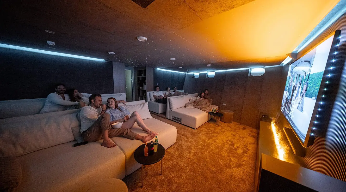 Cozy cinema lounge on Cristal yacht with plush seating and warm lighting