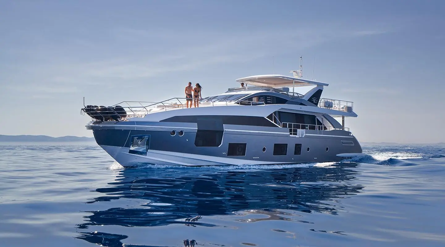 Motor yacht Aluminia Too sailing on calm blue sea under clear sky