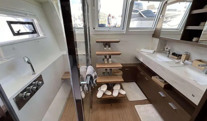 Master cabin with king bed, ensuite, wood flooring and seating area on yacht Atlantis