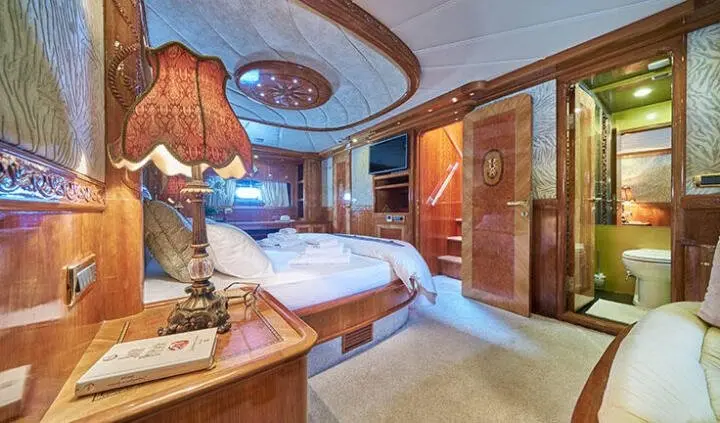 Master cabin on Lotus yacht with king bed and ensuite visible