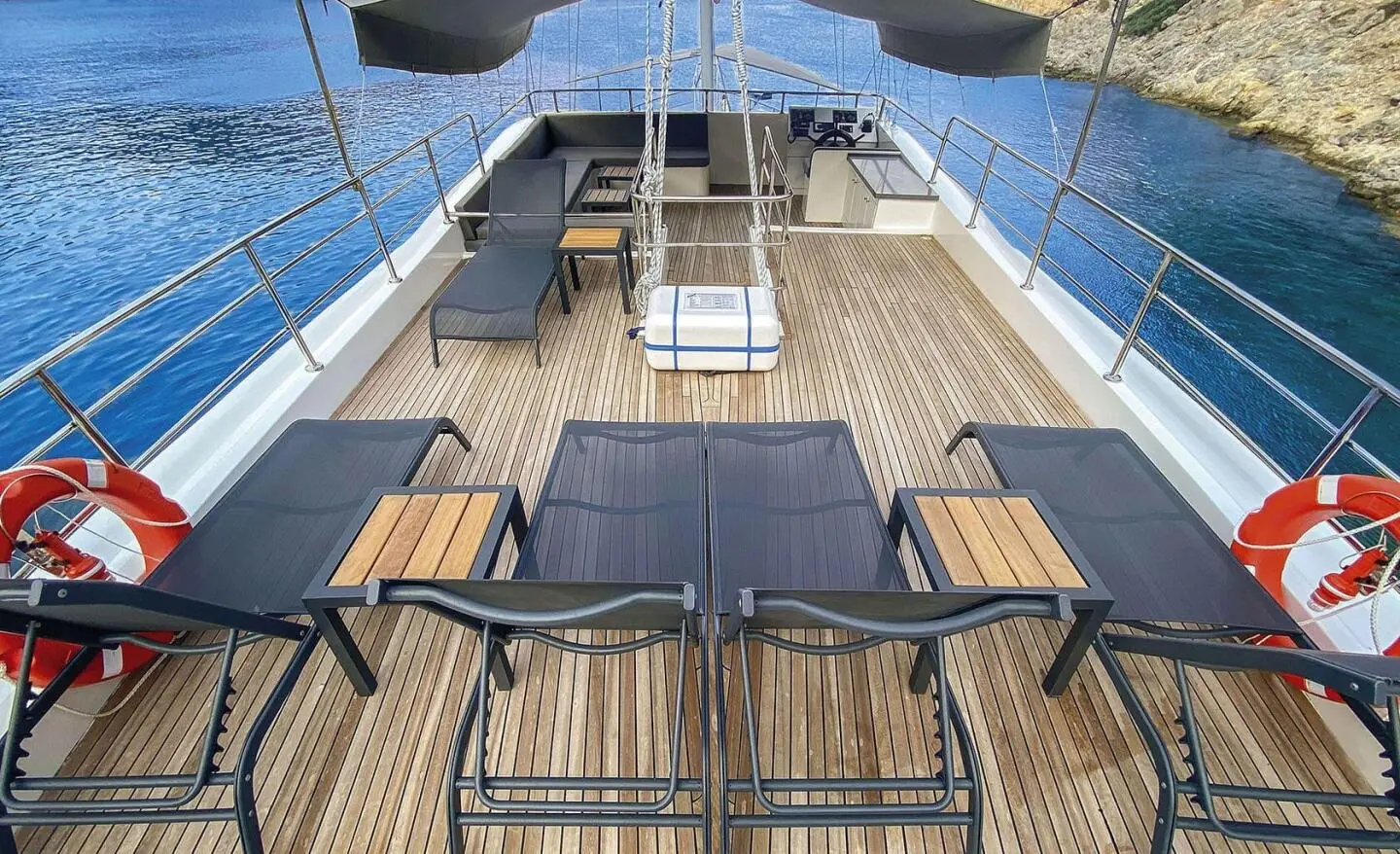 Maske 5 yacht deck at sunset with loungers and blue water backdrop