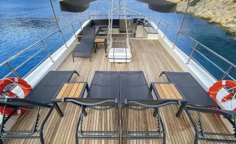 Maske 5 yacht deck at sunset with loungers and blue water backdrop