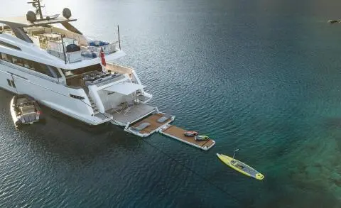 Morning Star yacht anchored in calm turquoise water with a wooden gangway approaching
