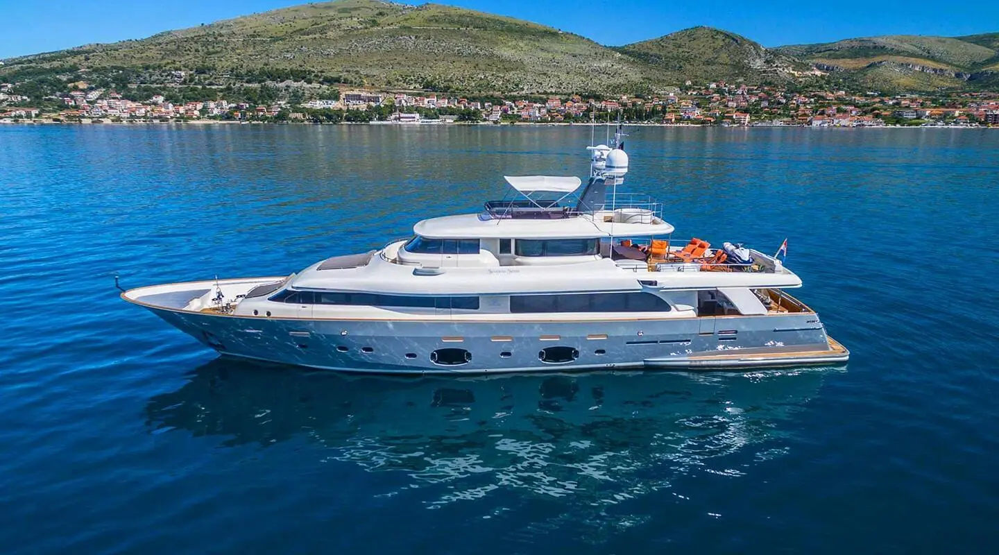 Motor yacht Sevent Sense on blue sea with sun loungers on the upper deck