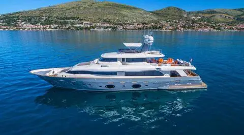 Motor yacht Sevent Sense on blue sea with sun loungers on the upper deck