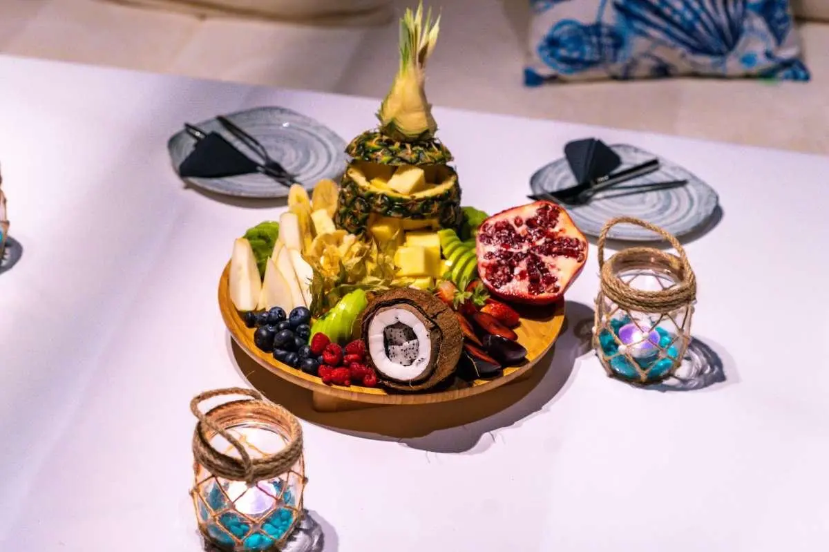 View of a golden fruit arrangement on a tray with drinks on a yacht table