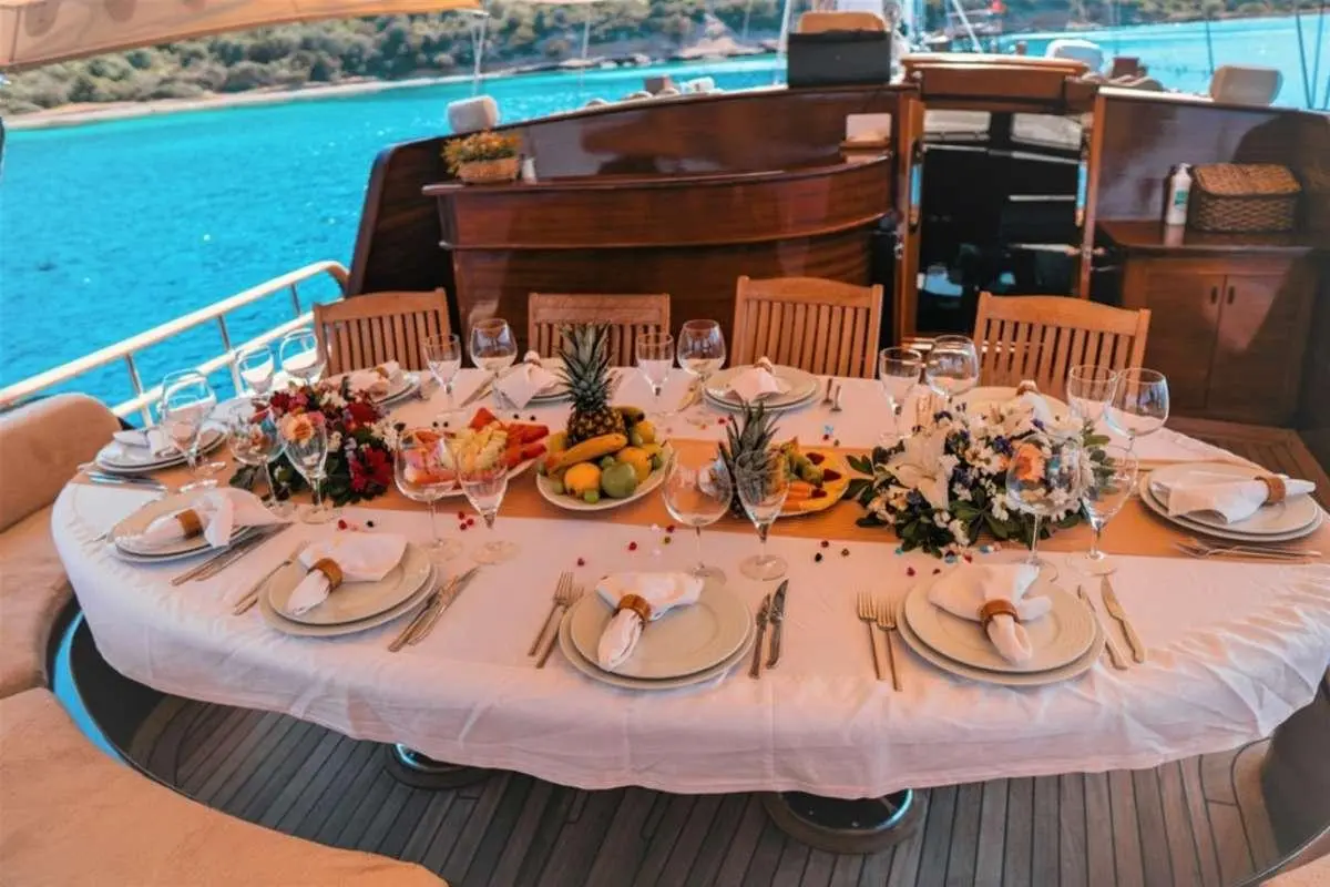 Wicked Felina yacht dining setup on deck with plates and glasses
