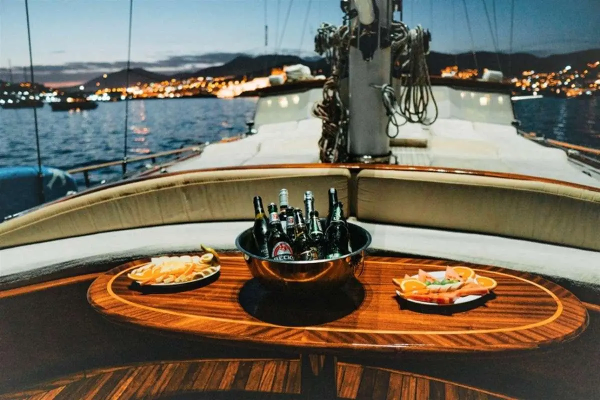 View from deck of Wicked Felina yacht with helm, wood table, and drinks