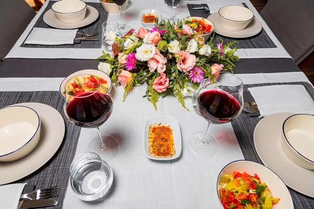 Overhead table setting on Bodrum Queen yacht with flowers, plates, and drinks
