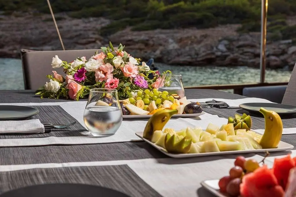 Bodrum Queen yacht exterior deck with fruits and flowers on table
