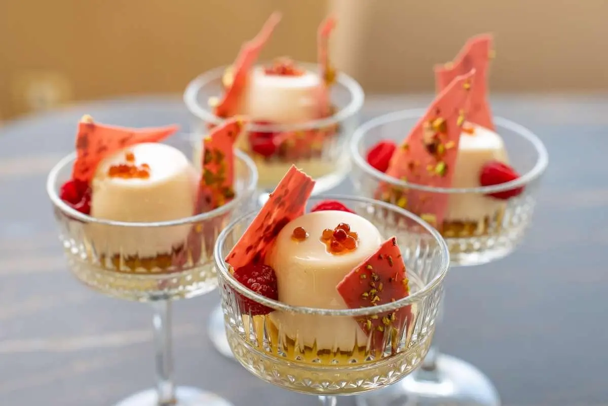 Love Story yacht dinner desserts plated in delicate glass stands on deck