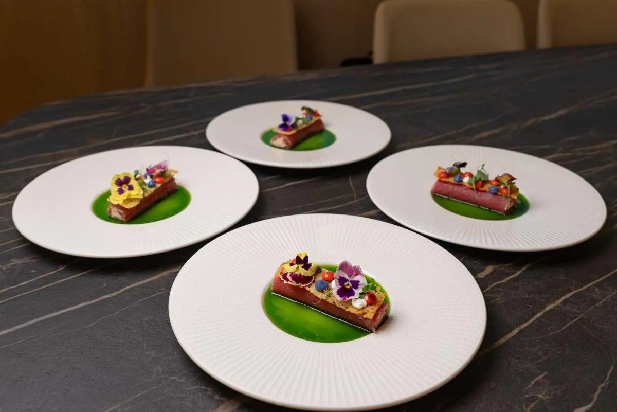 Plate array with small plated desserts on white plates aboard a yacht