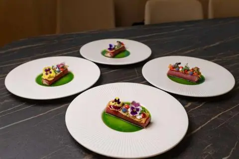 Plate array with small plated desserts on white plates aboard a yacht