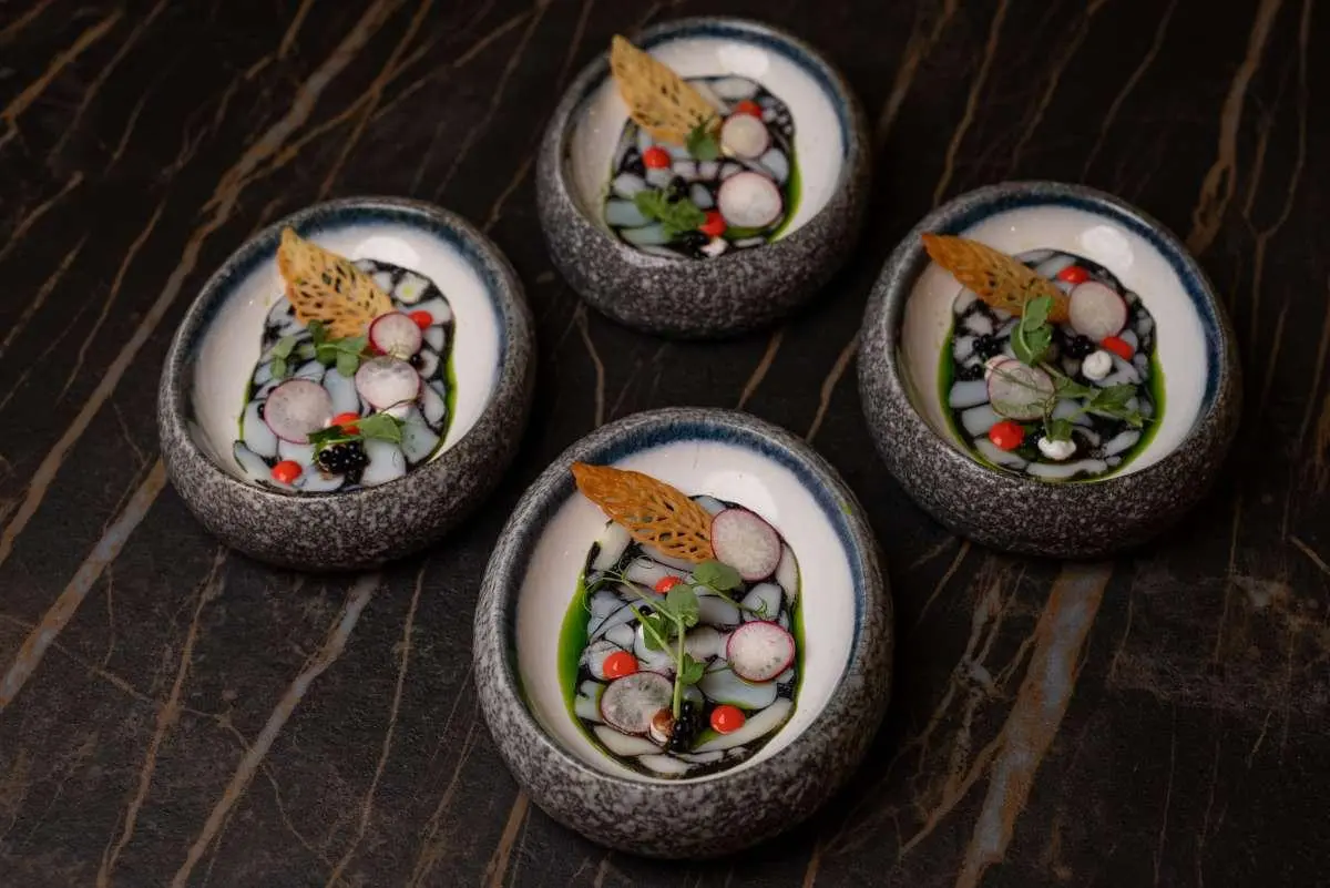 Love Story yacht crew menu images on round dishes with colorful food items