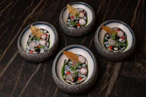 Love Story yacht crew menu images on round dishes with colorful food items