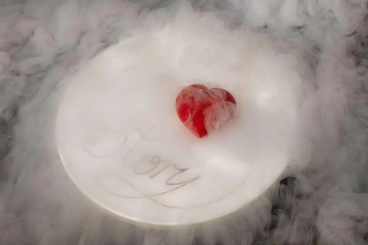 Love Story yacht name on a white dish with foamy beverage and a red heart