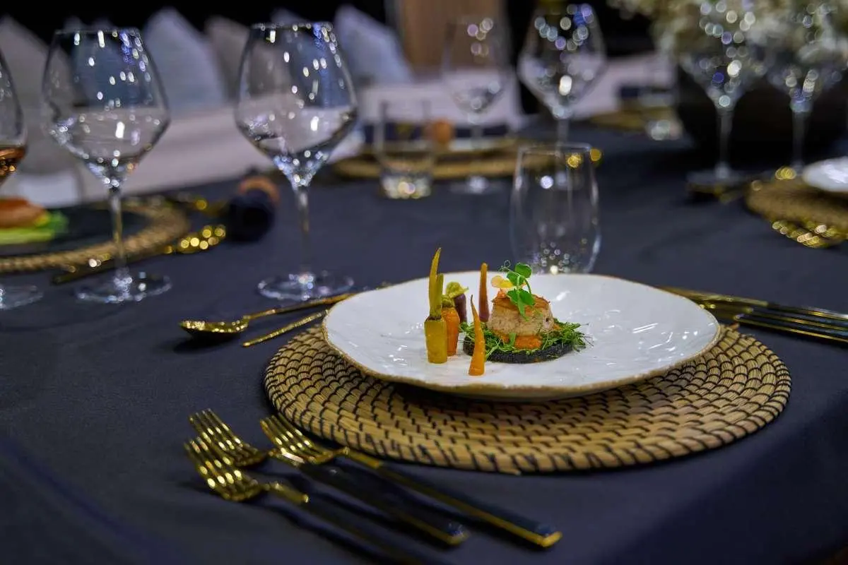 Elegant dining setup on a yacht table with plate, glassware, and napkin centerpiece