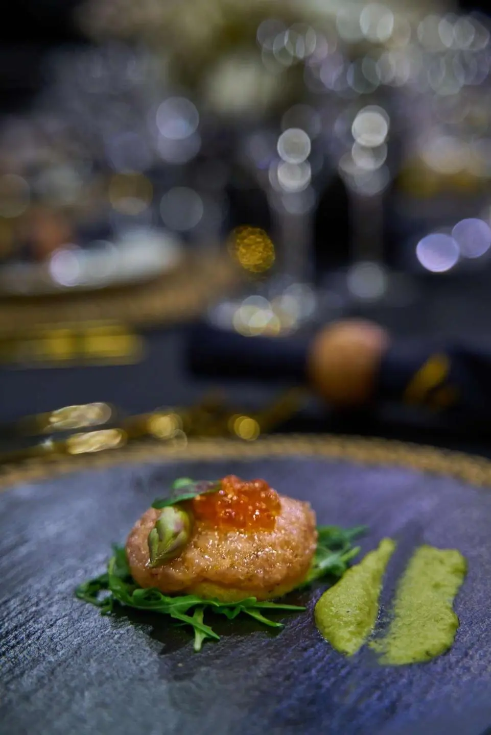 Close-up view of a plated appetizer on a blue patterned table onboard Rara Avis yacht