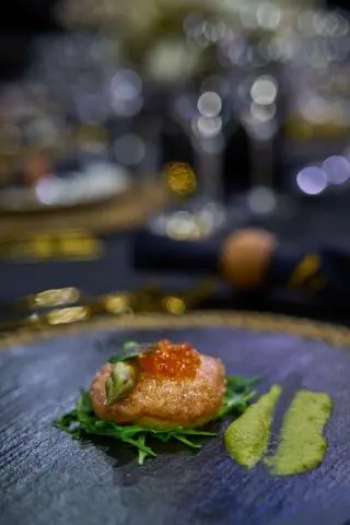 Close-up view of a plated appetizer on a blue patterned table onboard Rara Avis yacht