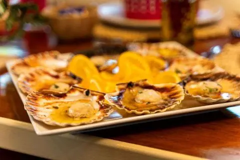 Cesarica yacht charter dining scene with a plate of nachos and toppings