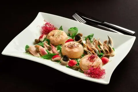 Cesarica yacht with a plated dish on deck, scene shows seafood appetizers
