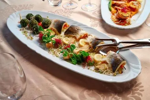 Cesarica yacht scene with a long plate of skewered grilled vegetables and meat