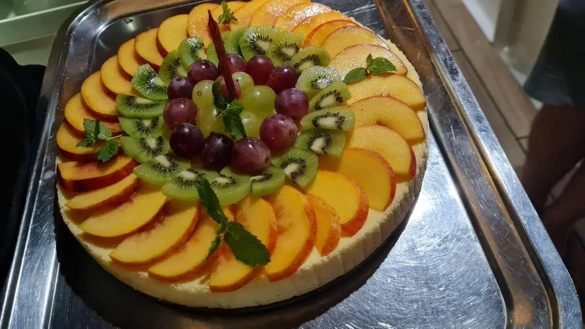 Mendula yacht docked with a circular fruit platter on a table in foreground