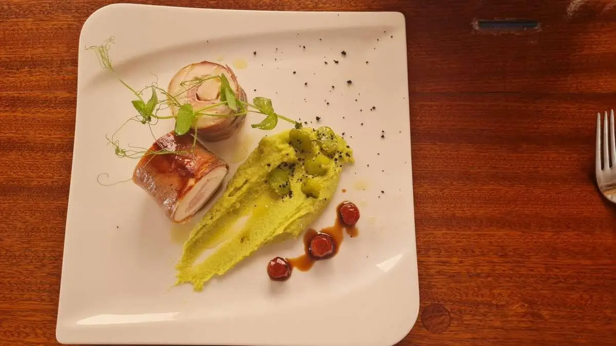 Mendula yacht viewed from deck with plated appetizers on a table