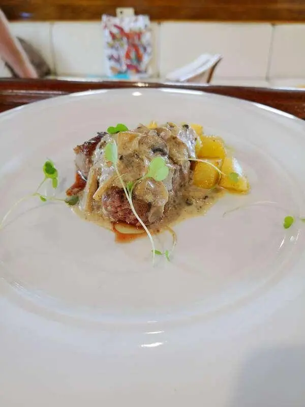 Libra yacht image showing a plated dish with sauce, greens, and garnish