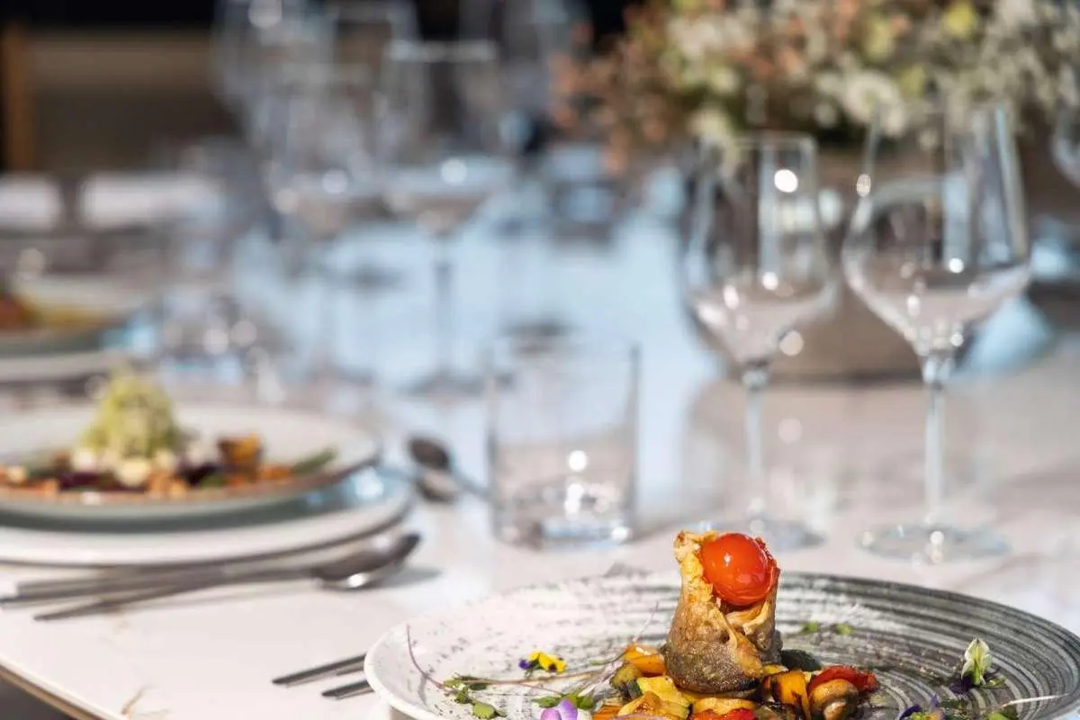 Olimp yacht table set with elegant place settings and a plated dish
