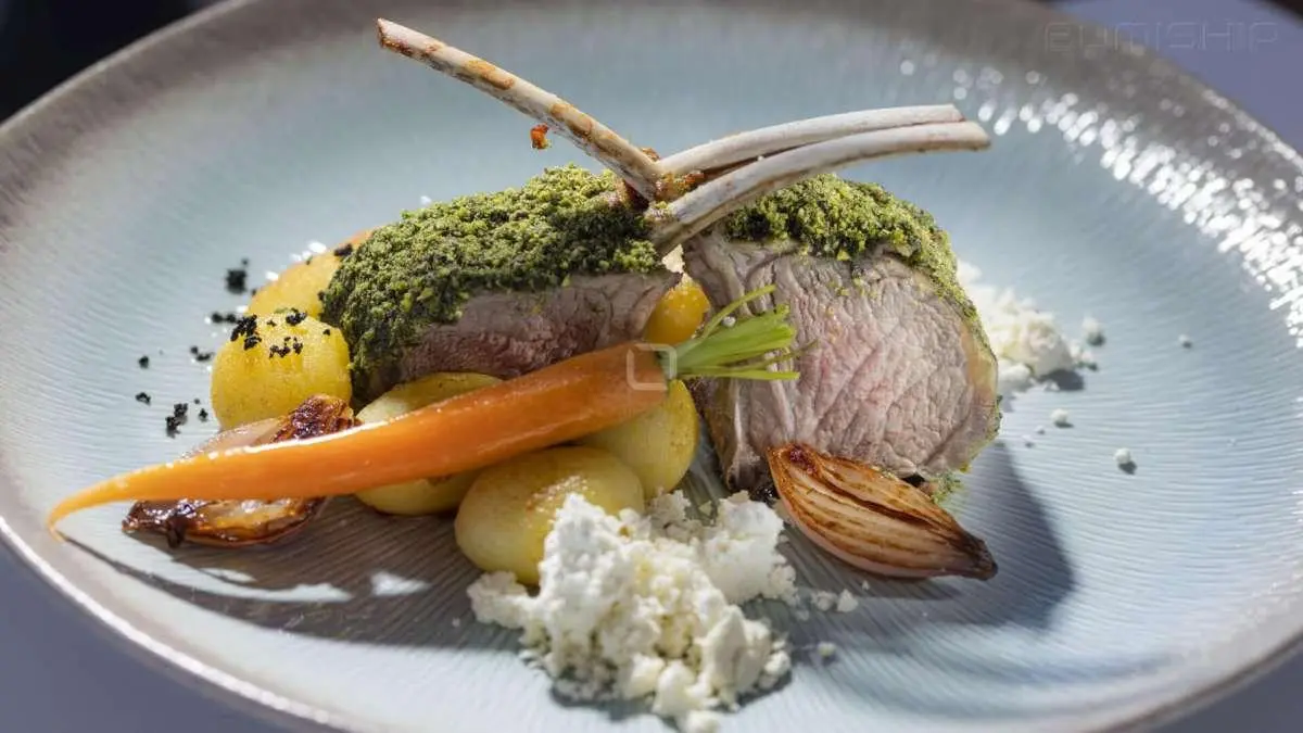 Omnia yacht dining scene with plated seafood and vegetables on a table
