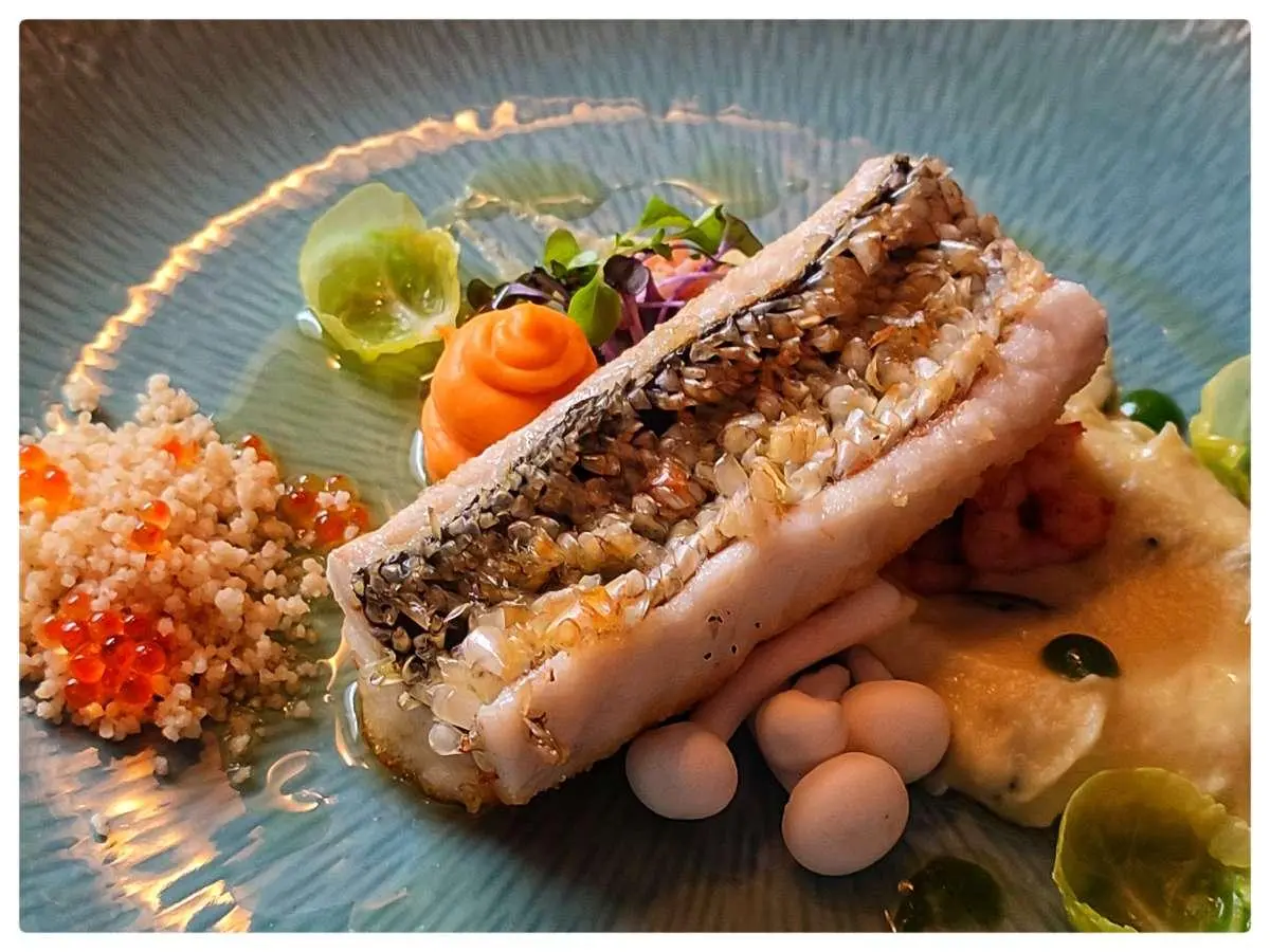 Omnia yacht seen from above with plated meal and lemon on table